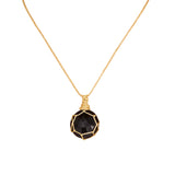 Necklace with a black faceted pendant on a white background