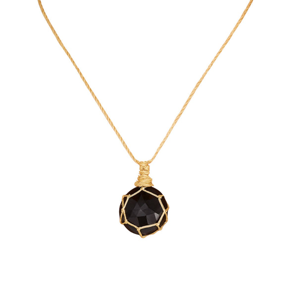 Necklace with a black faceted pendant on a white background