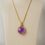 Ayana Crystals raw amethyst pendant necklace on a gold macrame cord, designed for anxiety relief and peaceful sleep.