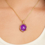 Ayana Crystals raw amethyst necklace in a gold macrame cord setting worn on a person's neck for anxiety relief.